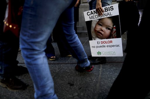 (AP Photo/Natacha Pisarenko). A woman holds a banner with a message that reads in Spanish: "Medicinal Cannabis, the pain can not wait", as she waits outside the Senate in Buenos Aires, Argentina, Wednesday, March 29, 2017. The Senate is expected to vot...