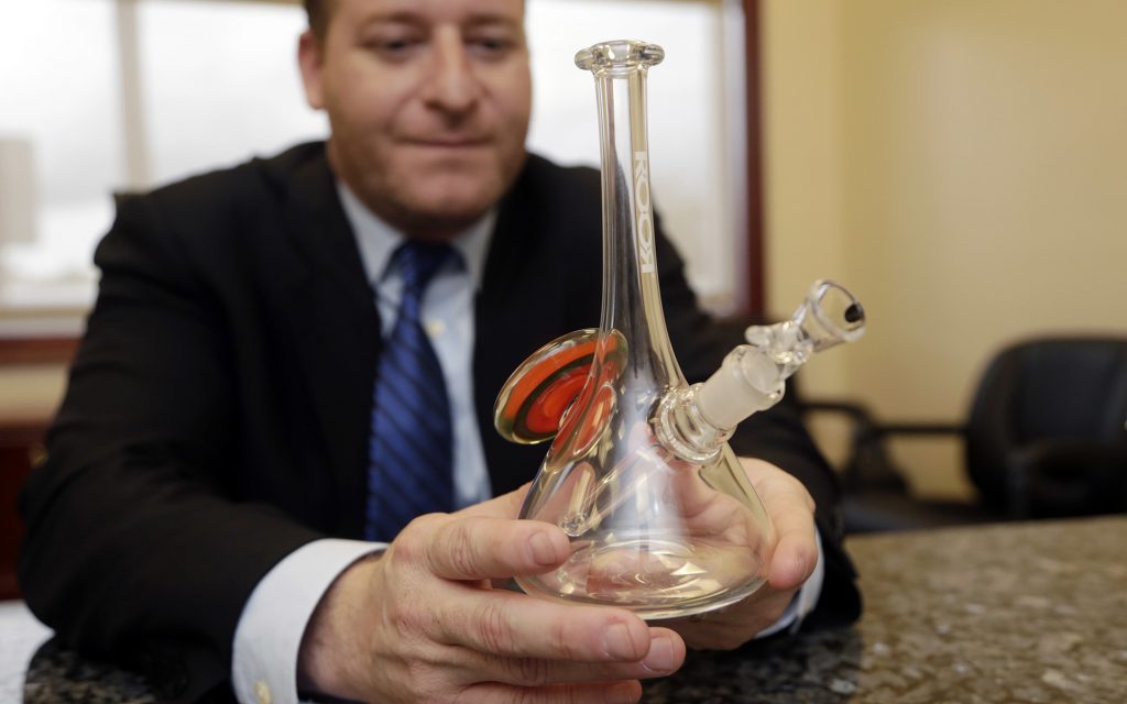 Attorney Jamie Sasson holds a counterfeit Roor bong at his office in Deerfield Beach, Fla. (AP Photo/Lynne Sladky)