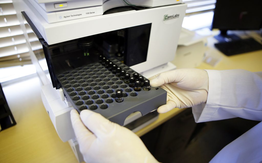 This photo taken on Friday, Jan. 4, 2013, shows a lab technician loading a tray of marijuana samples into a Chromograph at CannLabs in Denver. The Chromograph analyzes the samples and reports their chemical content and strength. From potency standards to labeling requirements and even regulations about pesticides and fungicides, marijuana production is largely unregulated, for now. That's why there are places like CannLabs in south Denver, where medical marijuana dispensaries and consumers can voluntarily have their marijuana and pot-infused edibles tested. (AP Photo/Ed Andrieski)