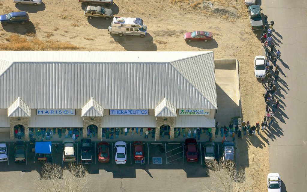 Retail demand in Pueblo County: A long line of buyers trails from a store selling cannabis in Pueblo West, Colo, Wednesday, Jan. 1, 2014. (AP Photo/John Wark)