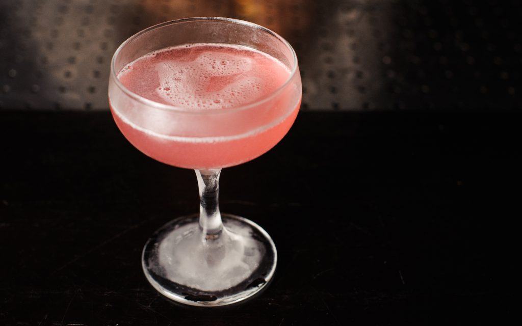Cosmopolitan pink cocktail on top of bar