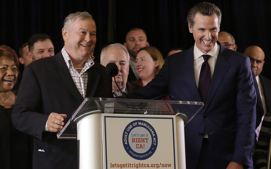 Rep. Dana Rohrabacher, R-Calif., left, smiles next to Lt. Gov. Gavin Newsom at a news conference after speaking in support of the Adult Use of Marijuana Act ballot measure in San Francisco, Wednesday, May 4, 2016. (AP Photo/Jeff Chiu)