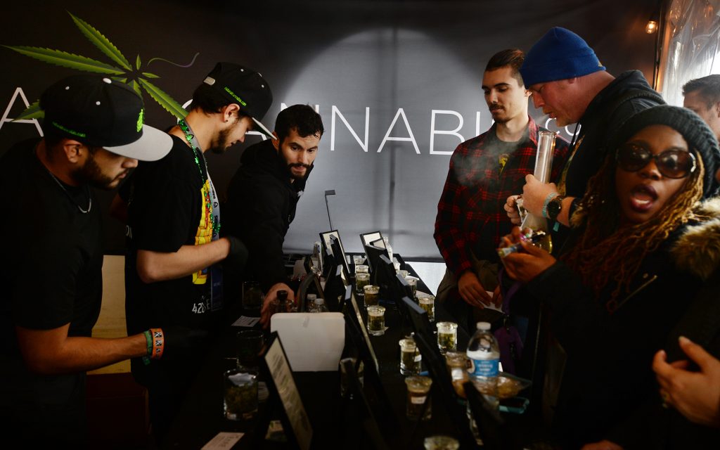 Event attendee sampling cannabis at the Natural Cannabis Co. booth during The Emerald Cup held at the Sonoma County Fairgrounds in Santa Rosa, California. (Erik Castro for Leafly)