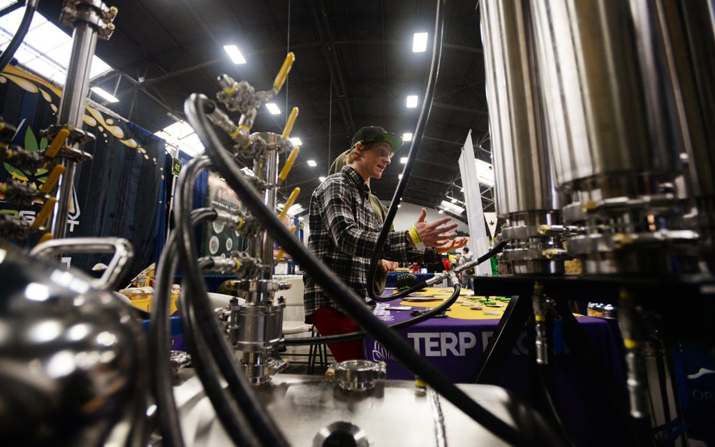 Daniel Steigman of BHOGART explaining his company's butane extractors to attendees at The Emerald Cup held at the Sonoma County Fairgrounds in Santa Rosa, California. (Erik Castro for Leafly)