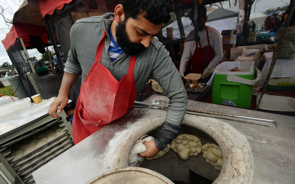 Naresh Kumar making nan at the Indian Gourmet stand during The Emerald Cup held at the Sonoma County Fairgrounds in Santa Rosa, California. (Erik Castro for Leafly)