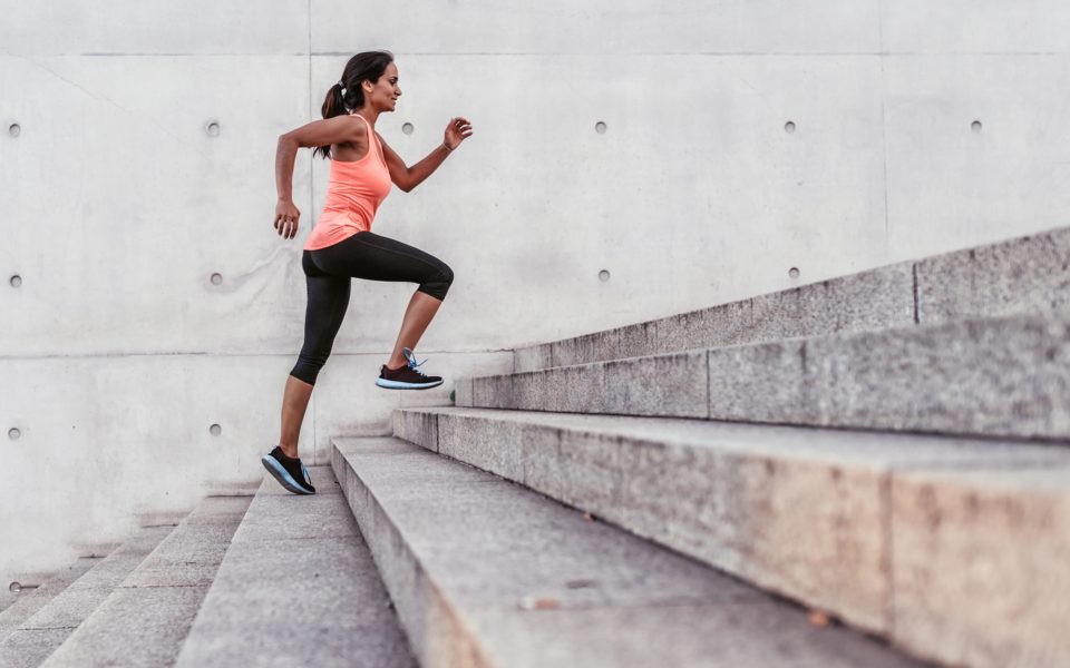 latina sports woman running up outdoor stairway in berlin